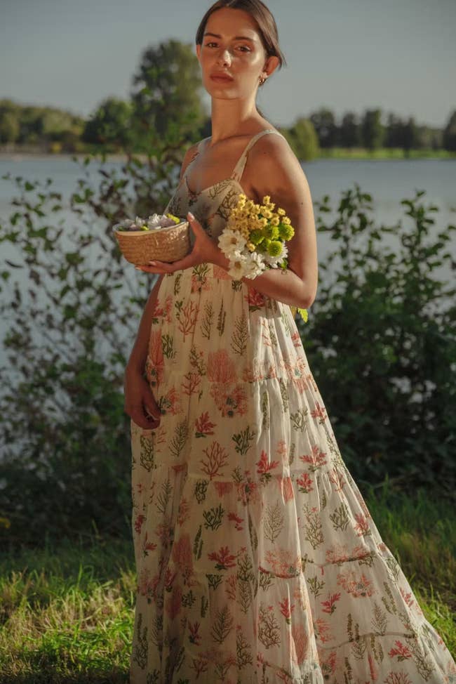 model wearing tiered summer dress in meadow