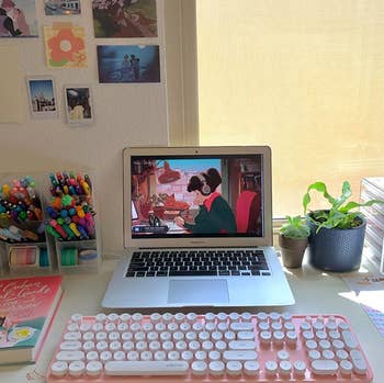 reviewer photo of a pink keyboard and mouse set with a laptop on a desk
