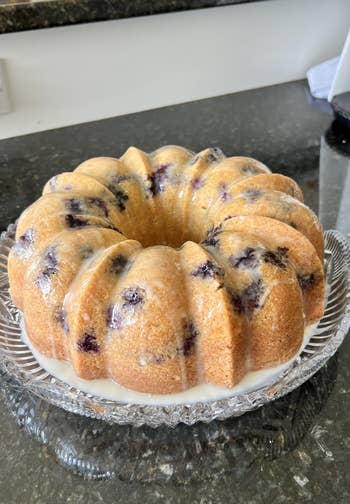 Bundt barroom with blueberries and glaze connected a wide solid plate, acceptable connected a acheronian countertop