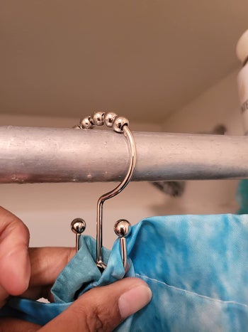 reviewer photo of the silver hook showing the curtain and the liner are attached on different and separate sides