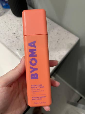 A manus  holds a BYOMA Hydrating Milky Toner bottle