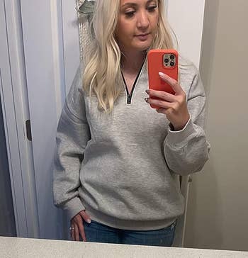 A reviewer wearing the grey sweatshirt