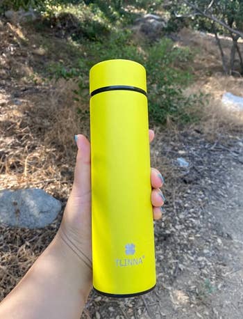 A yellow water bottle with twist on lid 