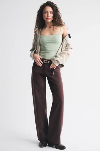 Model successful  casual wear, featuring a vessel  top, oversized jacket, and wide-leg pants, suitable for relaxed buying  attire
