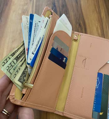 A pink wallet with lots of pockets for cards, IDs, paperwork, and money 