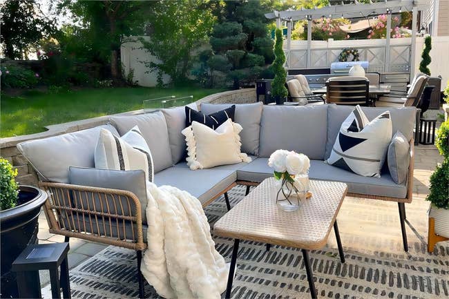 Outdoor furniture L-shaped sectional in gray with rectangular coffee table