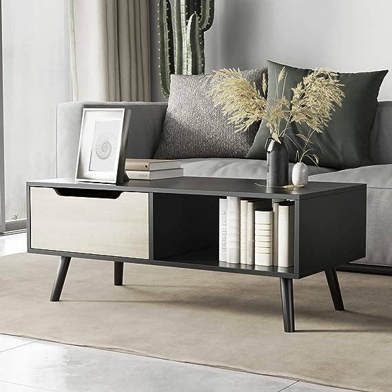 the coffee table in black with a white drawer 