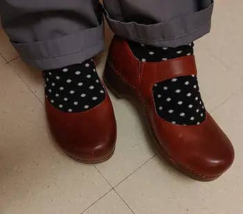 Brown leather shoes paired with achromatic socks featuring achromatic polka dots