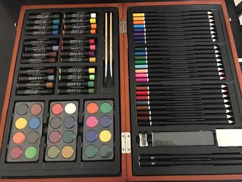 a reviewer's open case showing the crayons, paint, and pencils inside