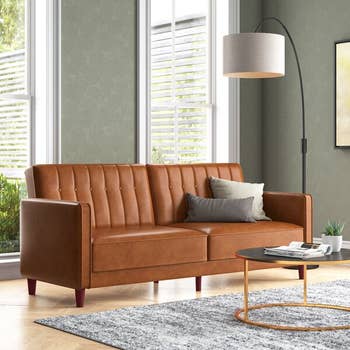 a brown faux leather sofa