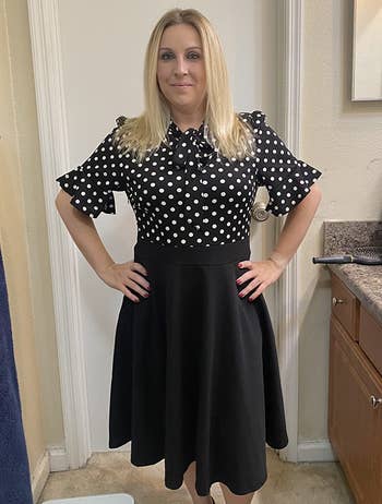 Image of reviewer wearing black polka dot dress