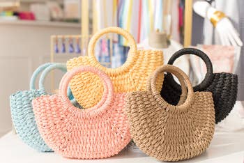 small ring handle woven totes in blue, pink, tan, black, and yellow