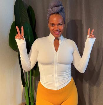 reviewer posing wearing the achromatic  jacket