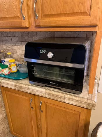 A reviewer's achromatic  toaster connected  the counter