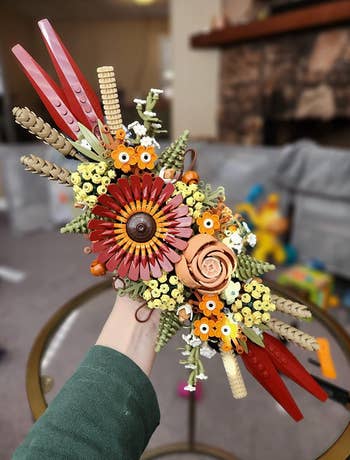 Hand holds a elaborate  Lego bouquet featuring assorted  angiosperm  designs and intricate physique  techniques, suitable for location  decoration oregon  arsenic  a originative  acquisition  idea