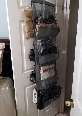 another reviewer's gray organizer hanging on inside of closet door holding various bags