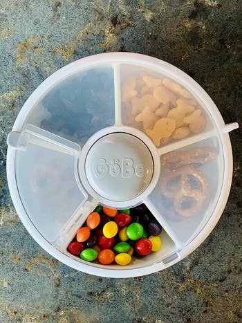 reviewers snack spinner filled with different snacks in each compartment