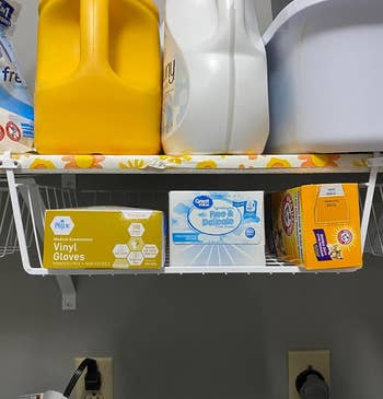 another reviewer's white basket on a laundry shelf