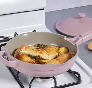 the pink pan with food cooking in it