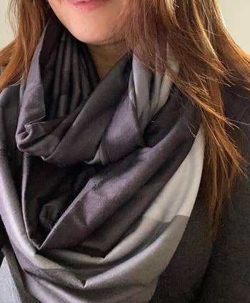 reviewer wearing the scarf in gray, blue, and cream tones 