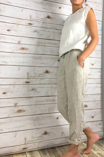 Front view of a model wearing the pants in dove white color