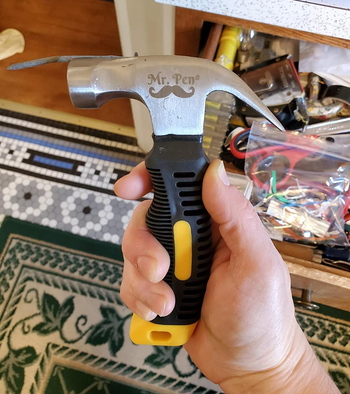 reviewer holding small hammer