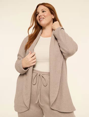 Person wearing comfy  lounge acceptable   with a waffle-knit cardigan and drawstring pants, showcasing relaxed, cozy benignant   for casual buying  attire