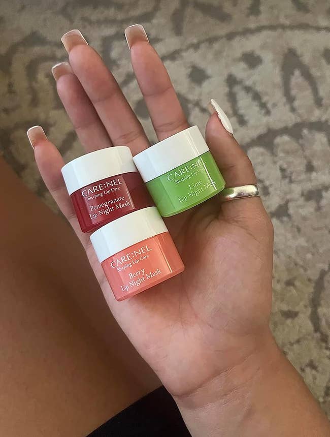 reviewer holding three lip masks in palm of hand