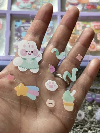 Hand holding various decorative stickers