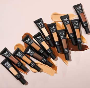 Tubes of TLB instauration  displayed connected  assorted  shades of swatched foundation