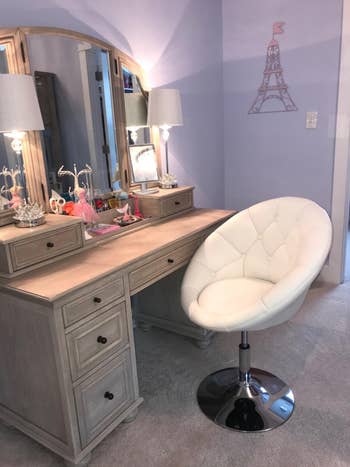 reviewer photo of a white round vanity chair at a vanity
