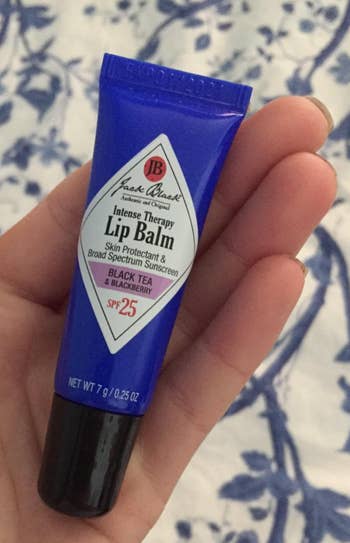 reviewer image holding tube of blackberry lip balm