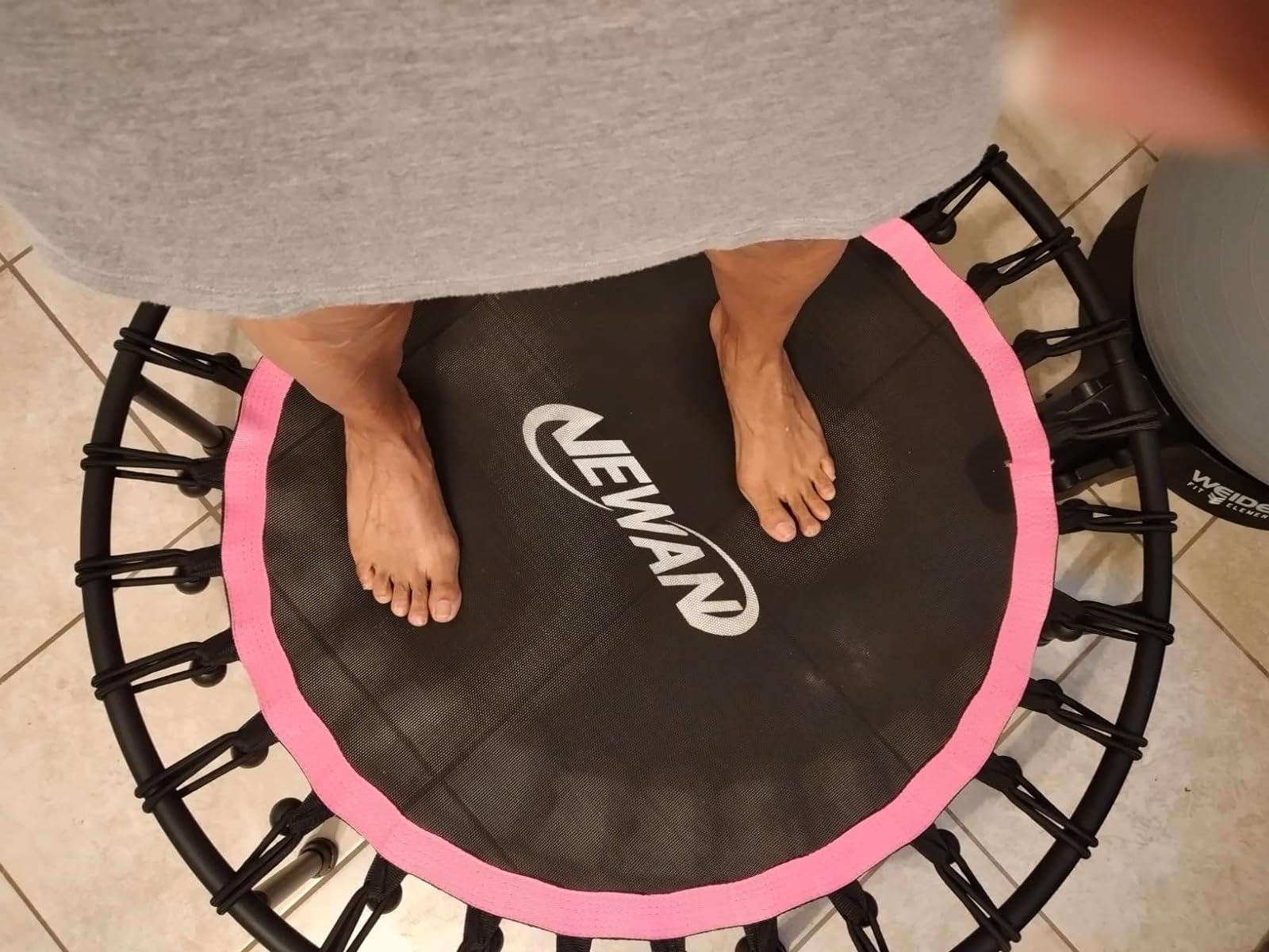 another reviewer standing on their pink trampoline