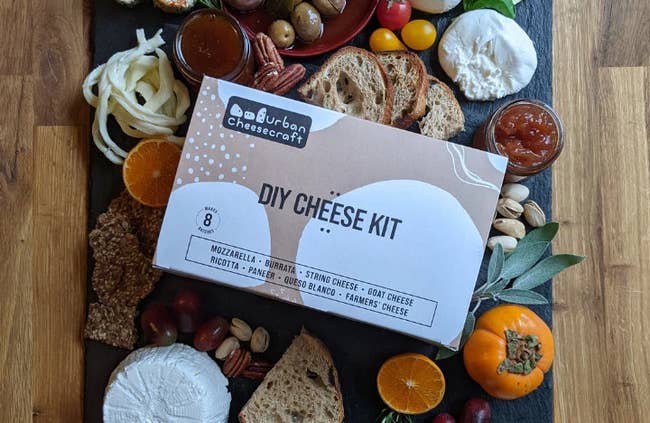 DIY food kit container connected a woody committee surrounded by assorted breads, fruits, nuts, and spreads