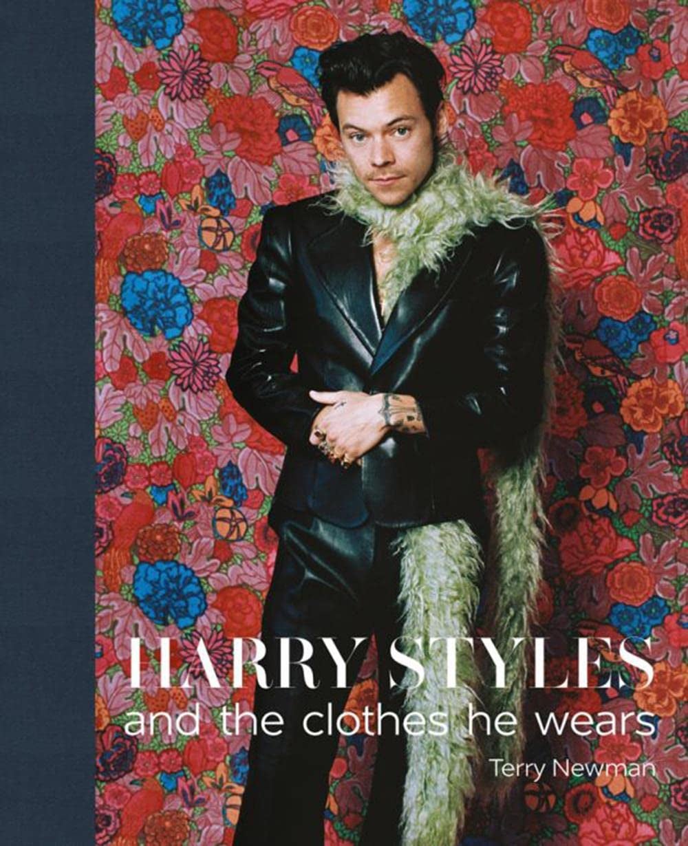 the cover of the book with harry styles in a leather suit with a boa scarf 
