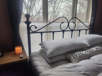 a reviewer's bed with two beckham hotel pillows on it