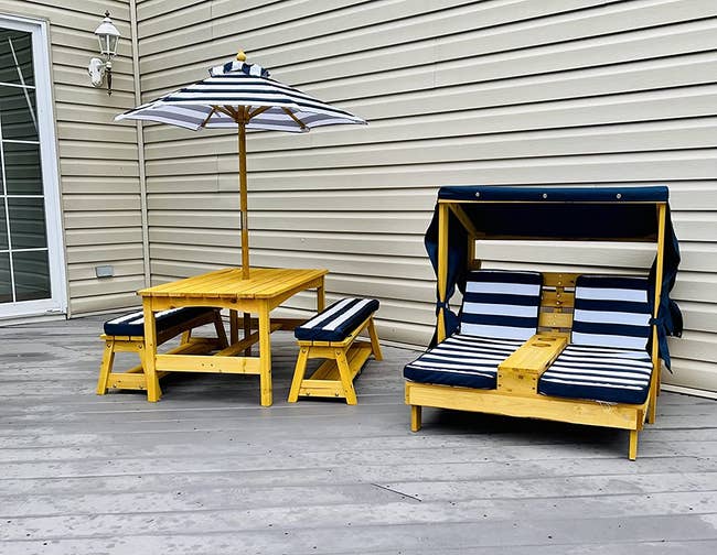 a tiny chaise cabana for children and a matching picnic table