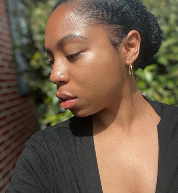 a reviewer wearing shimmering suncreen