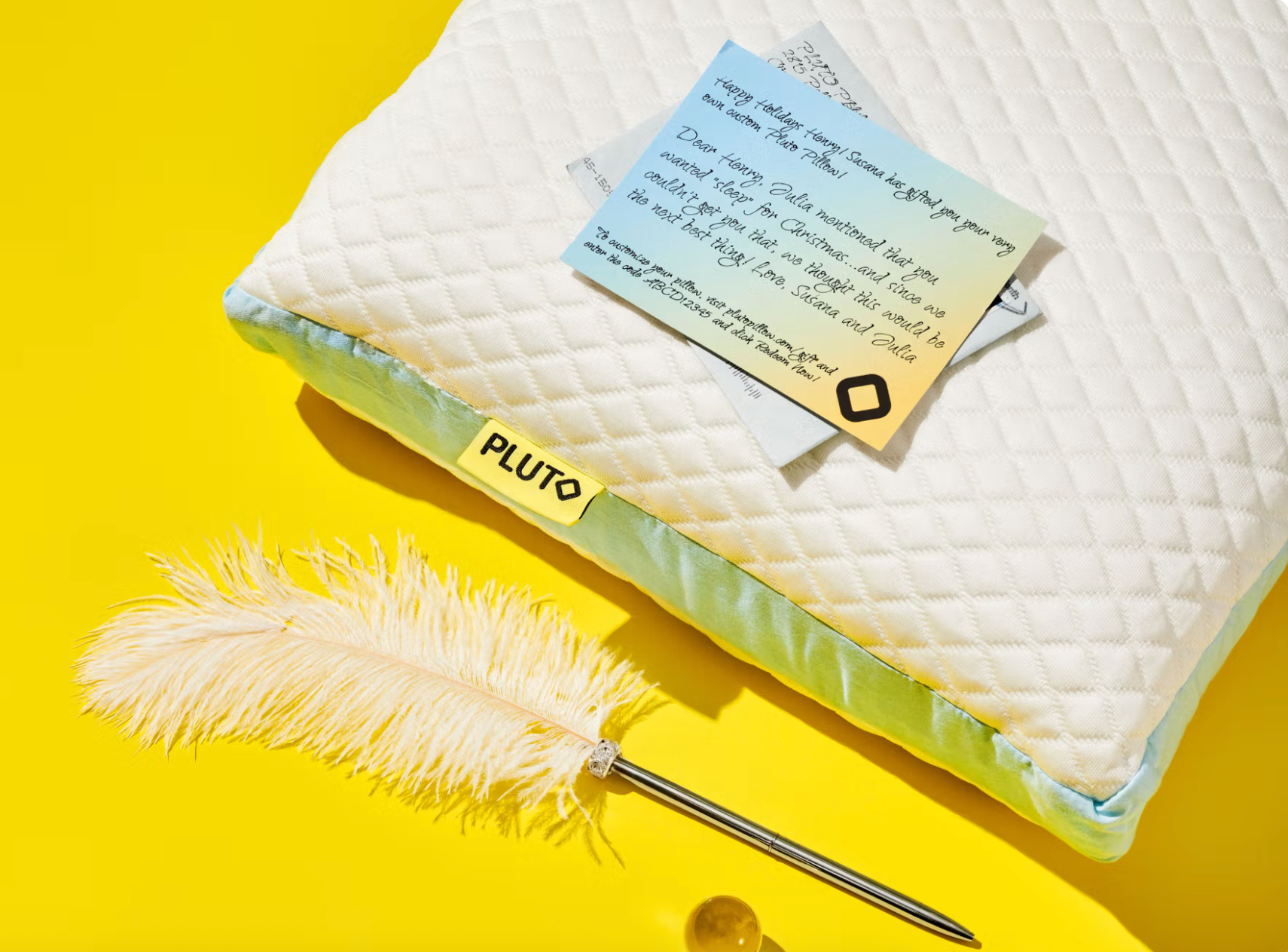 a pillow with a handwritten enactment      connected  apical  adjacent  to a feather pen