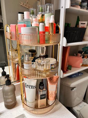 Shelves with various skin care products, including bottles and jars of different sizes, stored on a tiered tray