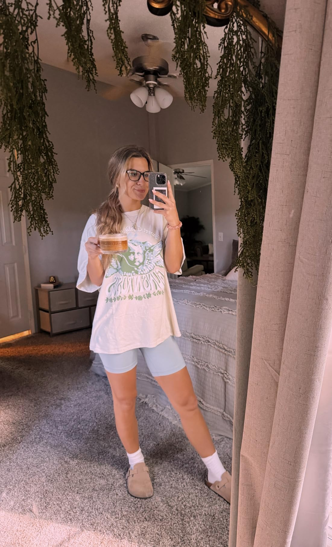 reviewer taking a reflector  selfie wearing cozy apparel  and the shoes with socks
