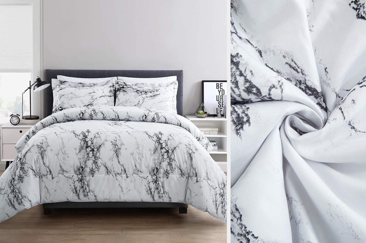 Black and white marble printed comforter with matching pillows on a hardwood floor next to white nighstand, close up of comforter material twisted
