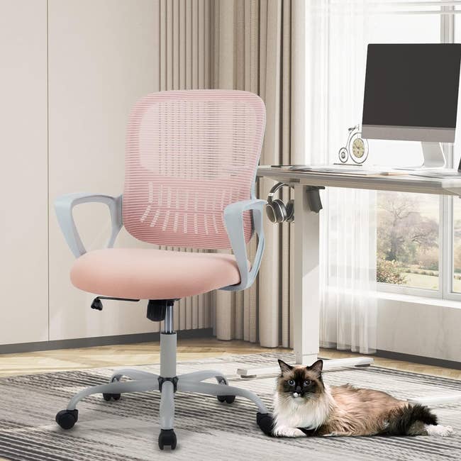 pink chair with light grey arms and swivel legs