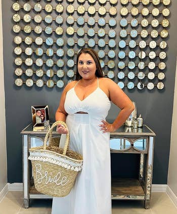 reviewer in white cutout dress with 'Bride' tote bag