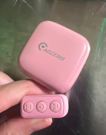Reviewer holding the pink version of the ring 