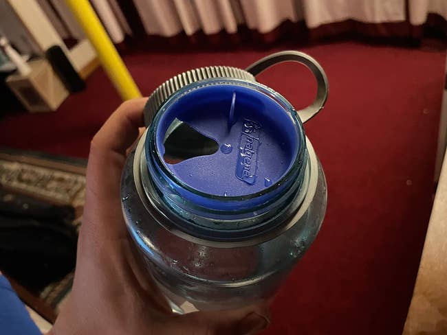 reviewer photo of the blue plastic topper in the mouth of a Nalgene bottle