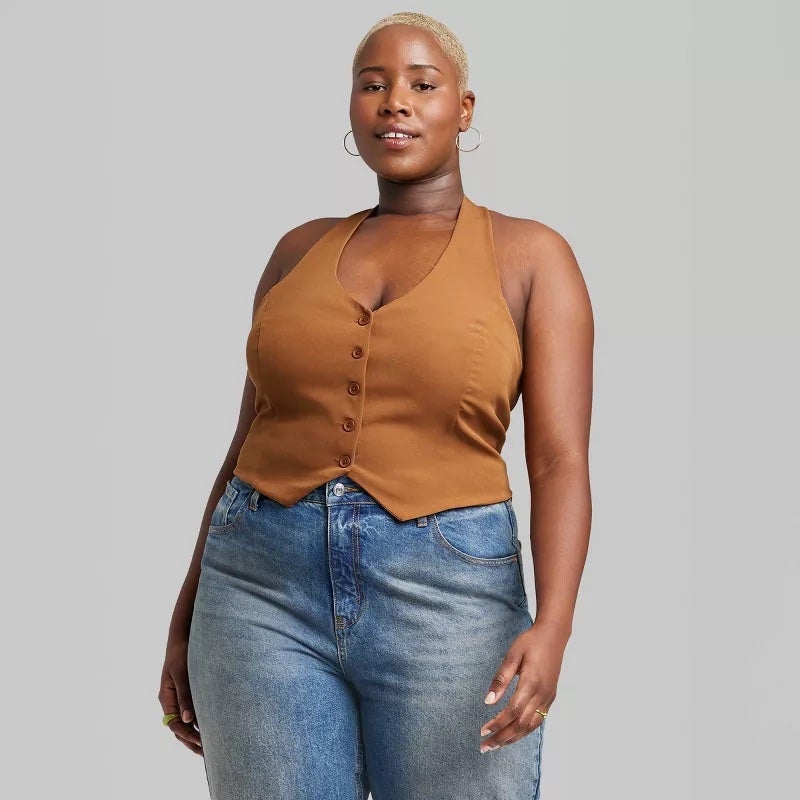 model in button down vest top with jeans