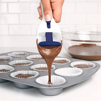 model using scooper to dispense batter into cupcake tins
