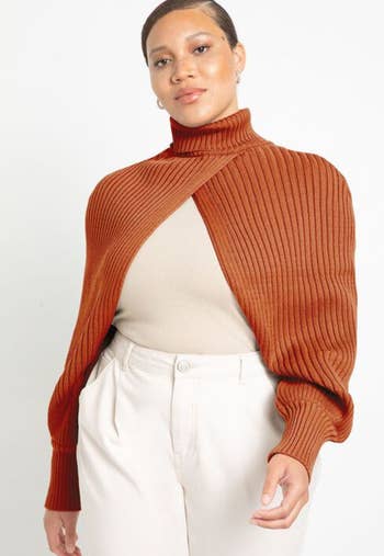 A model wearing the shrug in orange