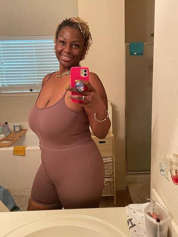 a reviewer wearing the dusty rose romper